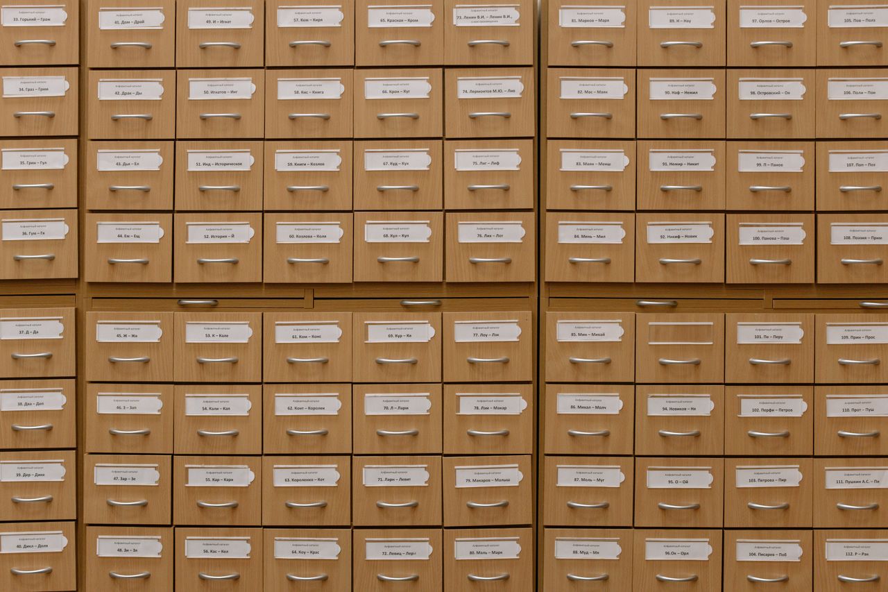 mobile-02 Close-up of labeled wooden storage drawers, perfect for organization concepts.